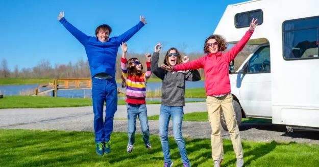 family-vacation-rv-travel-with-kids-happy-parents-with-children-have-fun-holiday-trip-motorhome-camper-exterior Family vacation rv travel-with TR